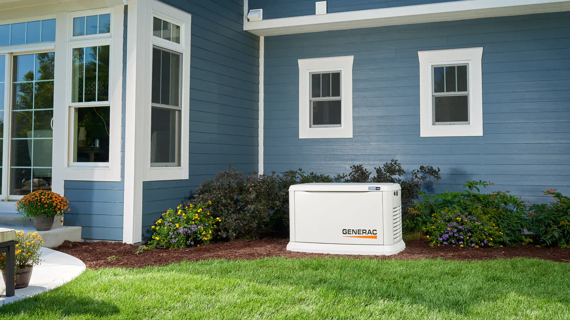 generac generator installed outside of residential house surrounded by beautiful landscape